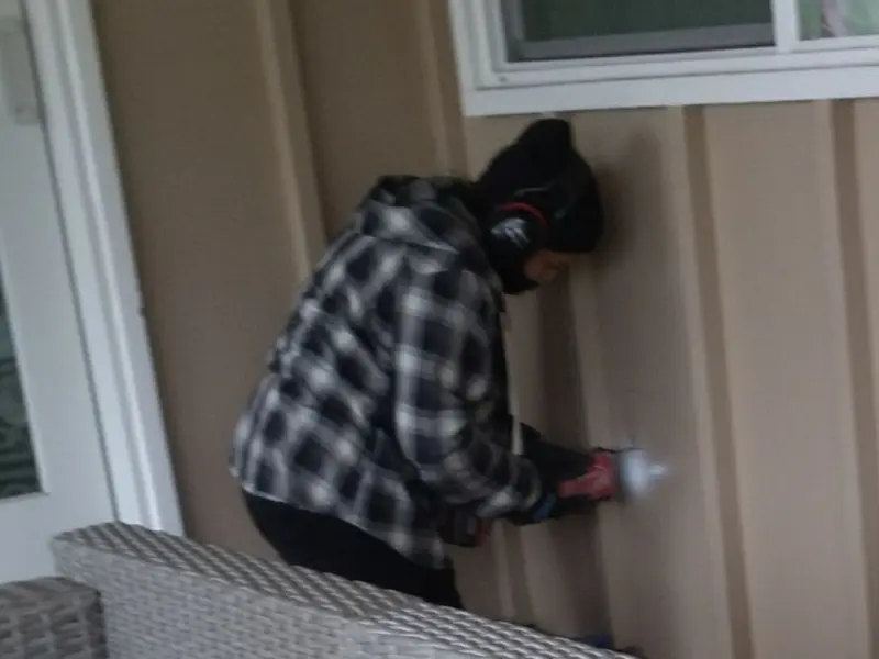 Professional electrician installing an exterior outlet in Kankakee